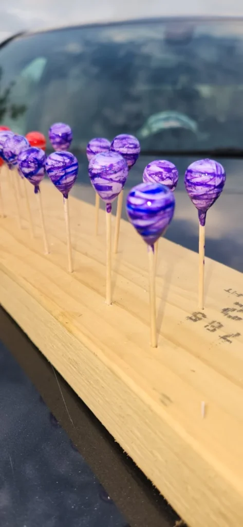Purple hand-painted floats during the making process